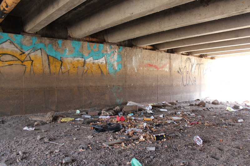 Tons of trash under a bridge