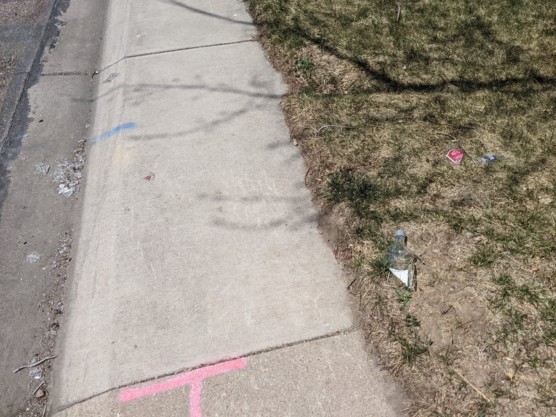 Broken glass bottle on the sidewalk